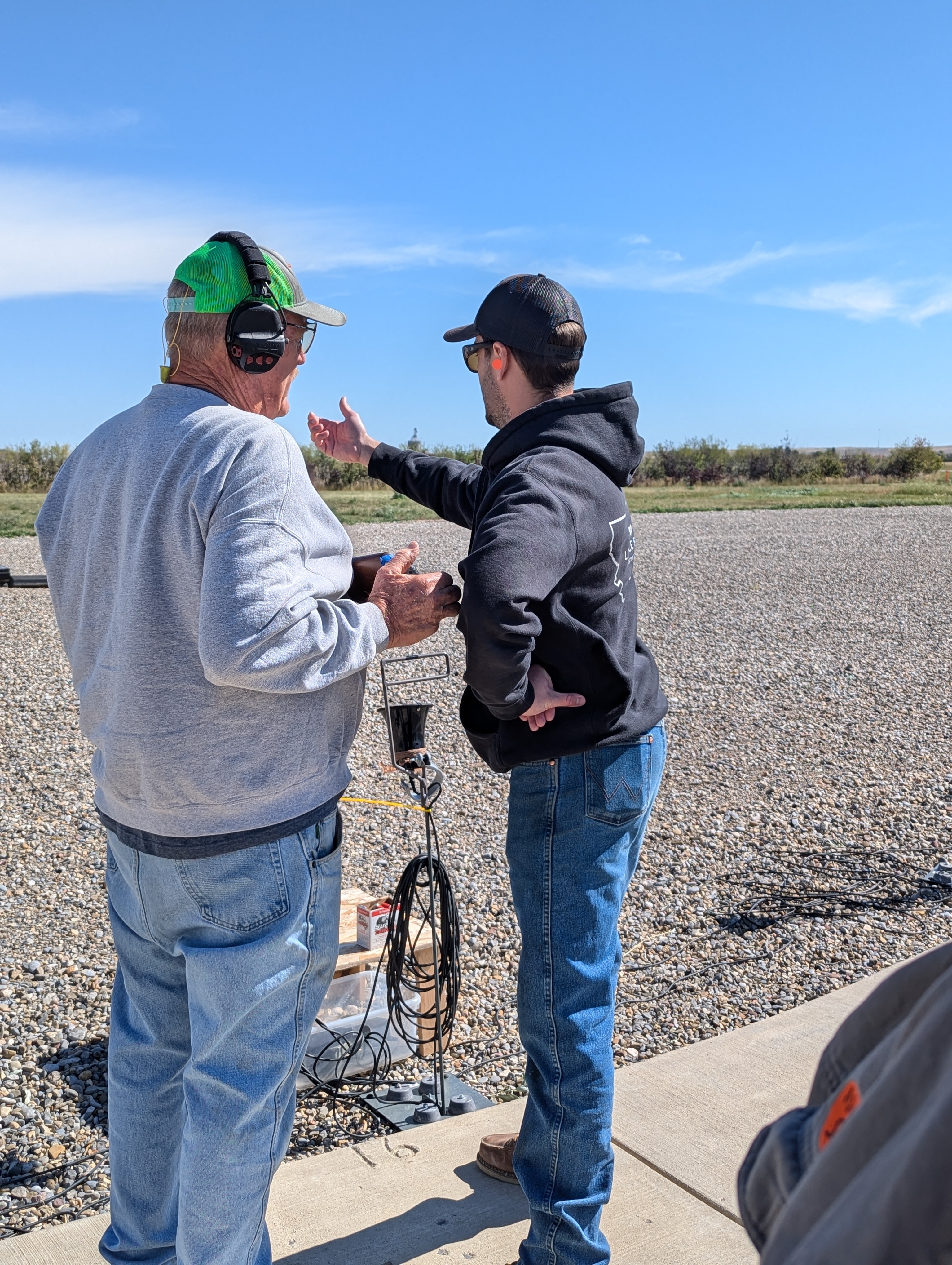 New shotgun leaders teach each other how to set up a proper "stance" to hold a shotgun properly.